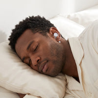 White-04 | High-Fidelity Washable Silicone Ear Plugs, worn, hugging pillow