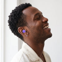 Purple-04 | High-Fidelity Washable Silicone Ear Plugs, worn, laughing profile