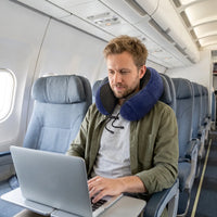 Dark blue | U-Shaped Memory Foam Airplane Neck Pillow, man working on a laptop on a plane