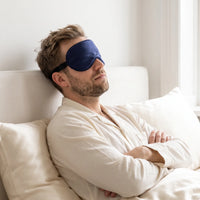 Navy | Soft Silk Blackout Sleep Mask, worn, dozing headboard