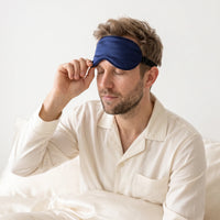Navy | Soft Silk Blackout Sleep Mask, worn, pulling down