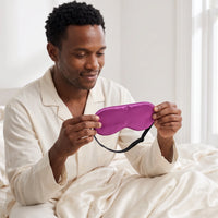 Orchid Purple | Soft Silk Blackout Sleep Mask, worn, holding bed edge