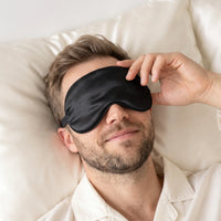 Black | Soft Silk Blackout Sleep Mask, worn, hand on mask