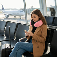 Pink | U-Shaped Memory Foam Airplane Neck Pillow, woman using her phone at the airport gate